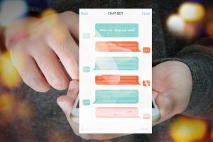 Chat bot and future marketing concept , automatic chatbot message screen with hand holding mobile phone bokeh background